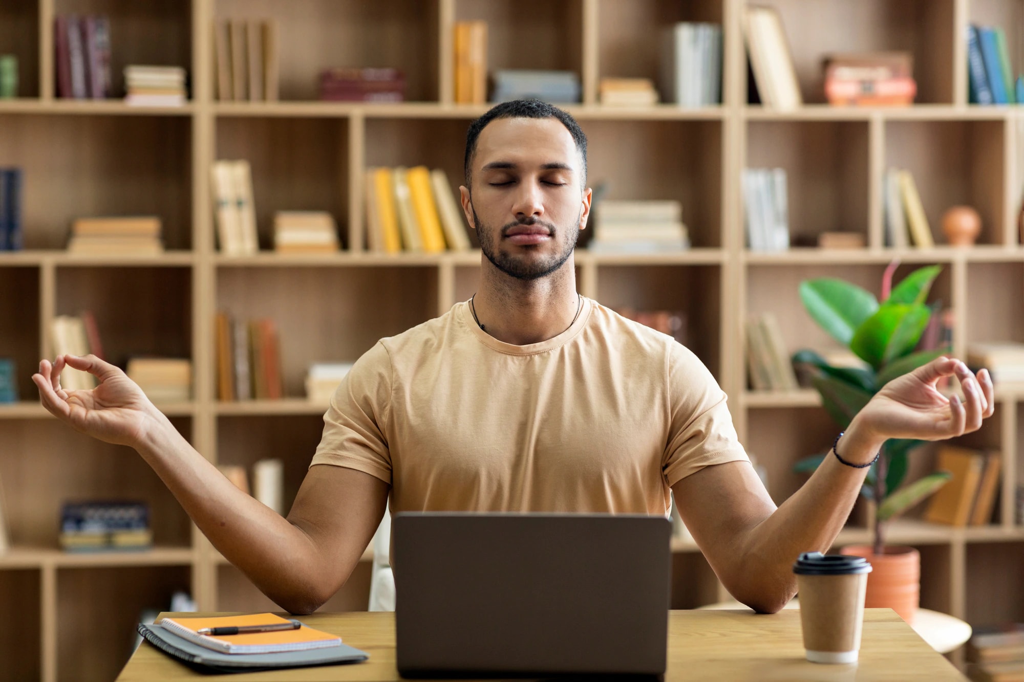 A man meditating at his desk