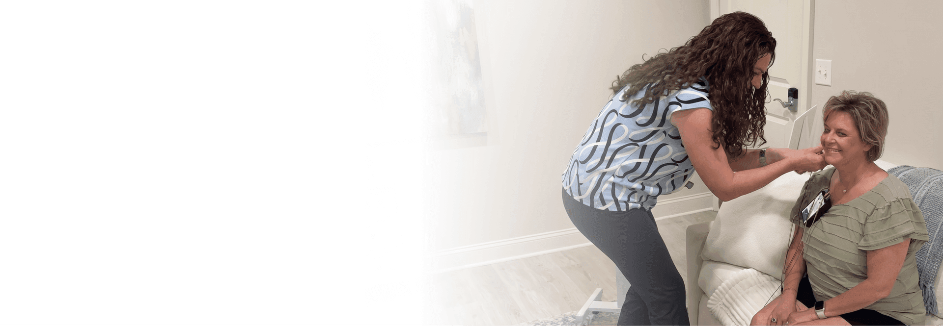 Practitioner placing neurofeedback sensors on a client